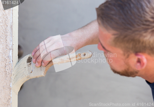 Image of Professional Painter Cutting In With Brush to Paint House Door F