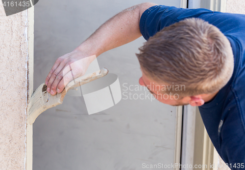 Image of Professional Painter Cutting In With Brush to Paint House Door F