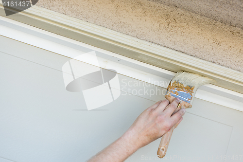 Image of Professional Painter Cutting In With Brush to Paint Garage Door 