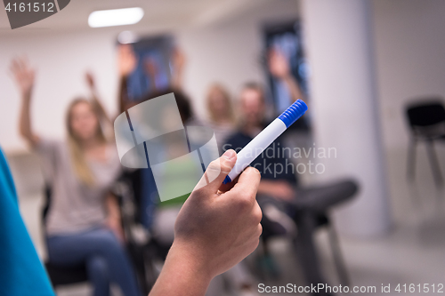 Image of close up of teacher hand with marker