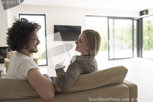 Image of Rear view of couple watching television