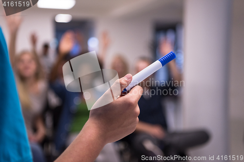 Image of close up of teacher hand with marker