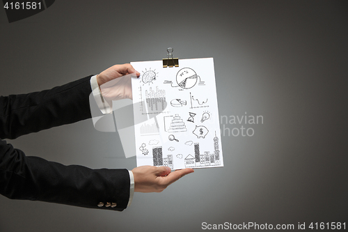Image of Male hands holding business plan