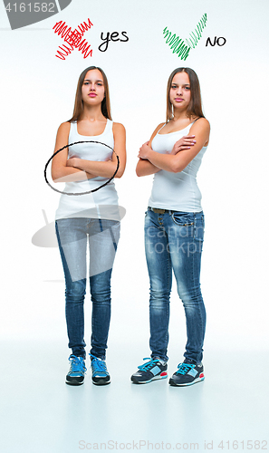 Image of conceptual portrait of two beautiful twin young women