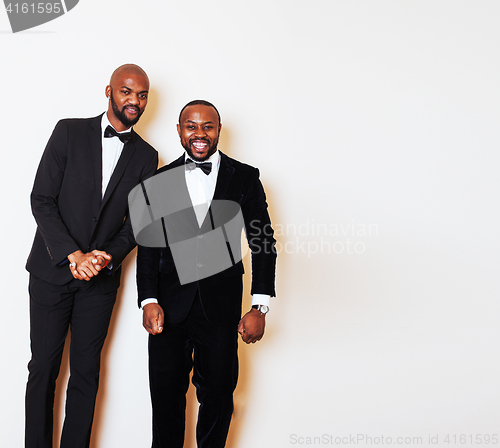 Image of two afro-american businessmen in black suits emotional posing, g