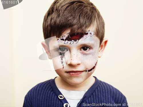 Image of little cute boy with facepaint like zombie apocalypse at hallowe