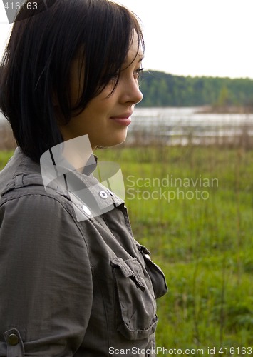 Image of pretty brunette near lake