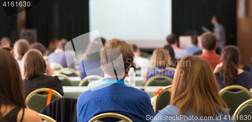 Image of Audience in lecture hall participating at business conference.