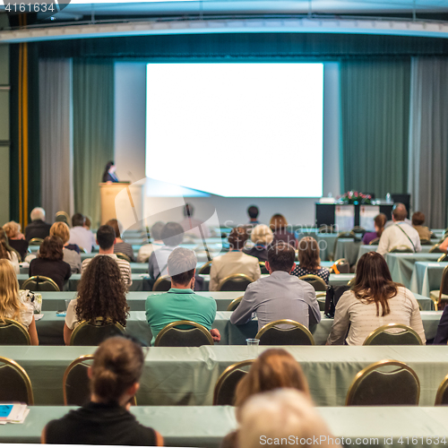 Image of Audience in lecture hall participating at business conference.