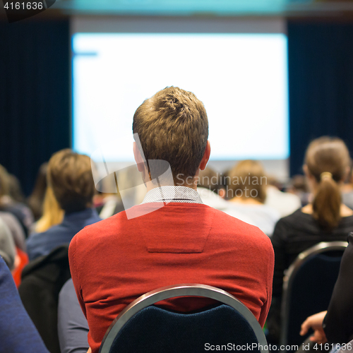 Image of Audience in lecture hall participating at business conference.