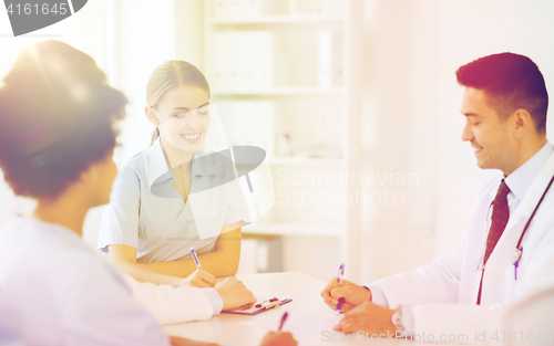 Image of group of happy doctors meeting at hospital office