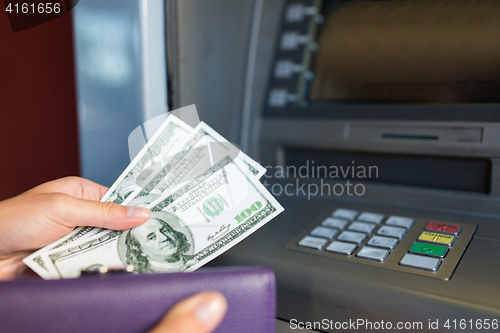 Image of close up of hand withdrawing money at atm machine