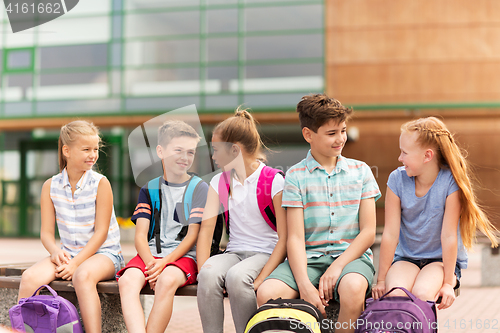 Image of group of happy elementary school students talking