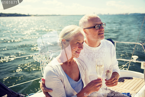 Image of senior couple drinking champagne on sail boat