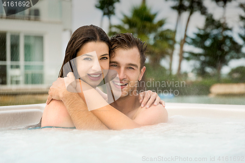 Image of Young couple in a jacuzzi