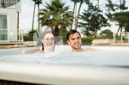 Image of Young couple in a jacuzzi