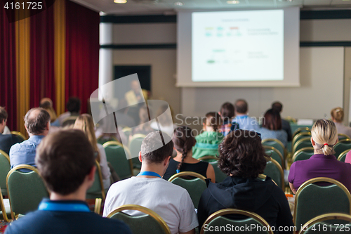 Image of Audience in lecture hall participating at business conference.