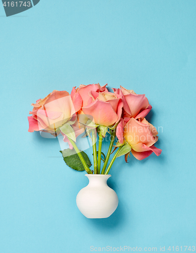 Image of pink roses in white vase