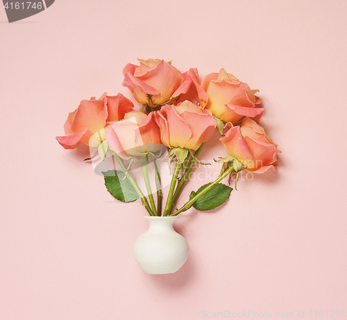 Image of pink roses in white vase