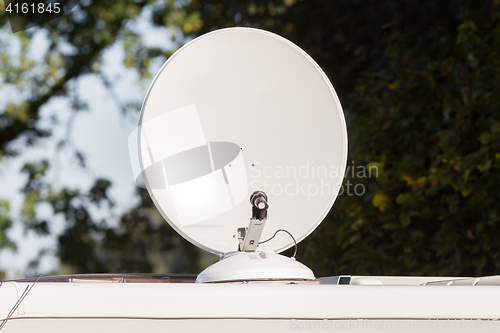 Image of Satellite dish on roof of camper van