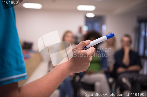 Image of close up of teacher hand with marker