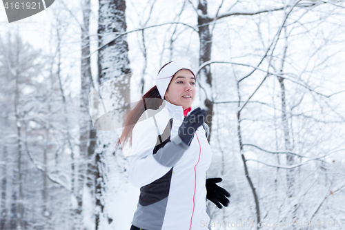 Image of Woman running in winter park