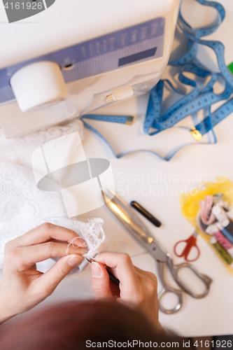 Image of Young girl engaged in needlework