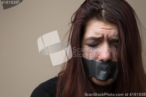 Image of Crying woman with gray tape