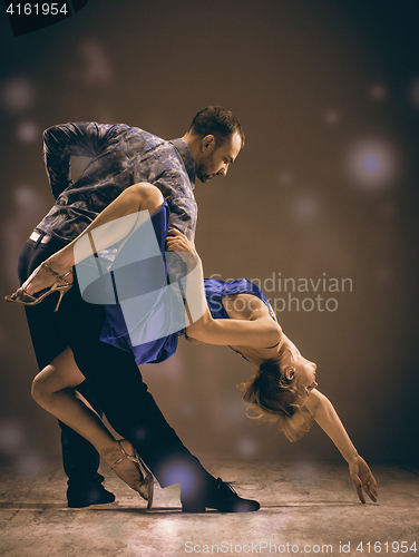 Image of The man and the woman dancing argentinian tango