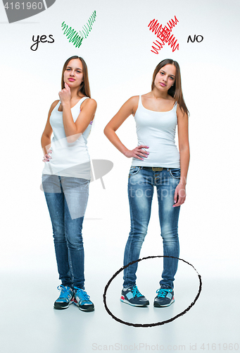 Image of conceptual portrait of two beautiful twin young women