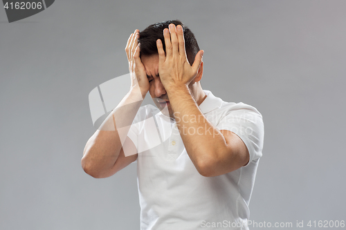 Image of unhappy man suffering from head ache