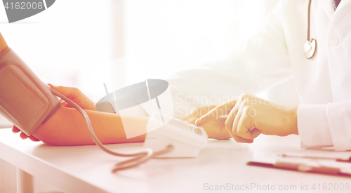 Image of doctor and patient measuring blood pressure