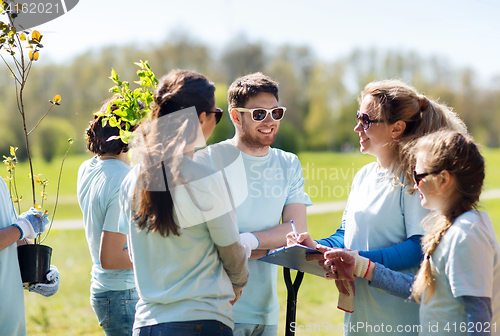 Image of group of volunteers planting trees in park