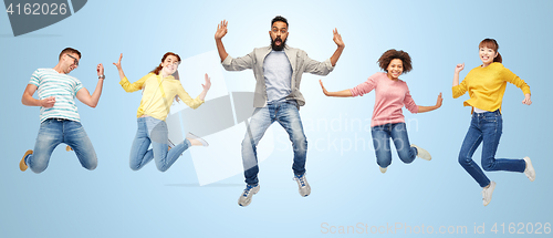 Image of international group of happy people jumping