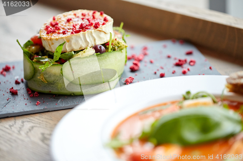 Image of goat cheese salad with vegetables at restaurant