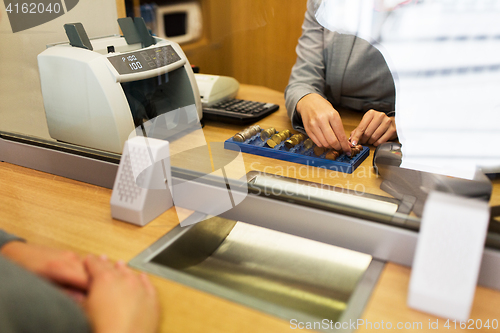 Image of clerk counting cash money at bank office