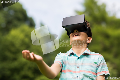 Image of boy with virtual reality headset outdoors