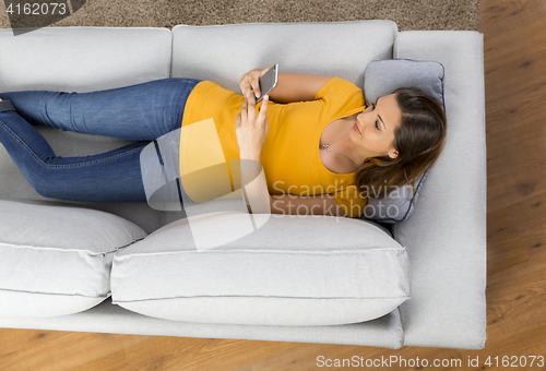 Image of Happy woman texting