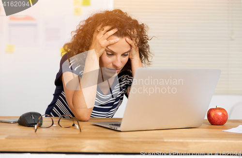 Image of Exausted woman at the office