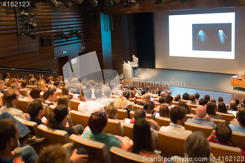 Image of Business speaker giving a talk in conference hall.