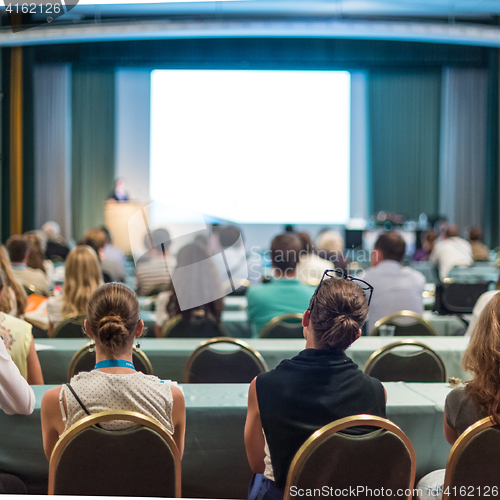 Image of Audience in lecture hall participating at business conference.