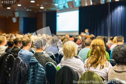 Image of Audience in lecture hall participating at business event.