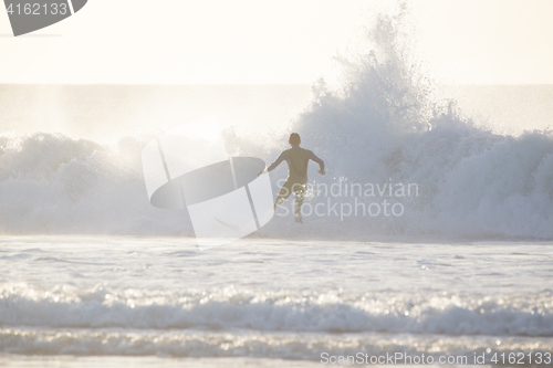 Image of Surfer riding a big wave.