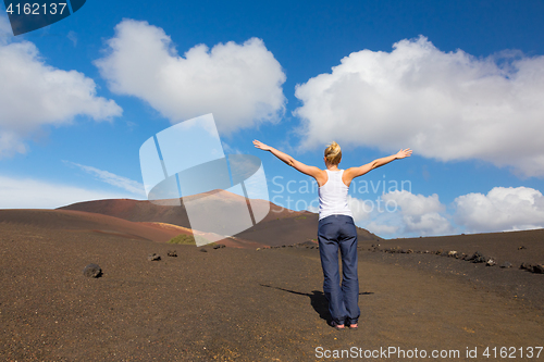 Image of Woman tracking to top of mountain.