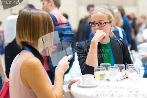 Image of People interacting during coffee break at medical conference.