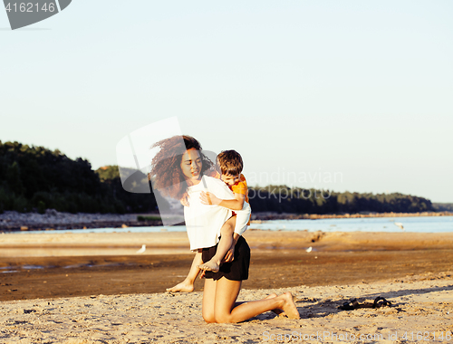 Image of pretty diverse nation and age friends on sea coast having fun, lifestyle people concept on beach vacations