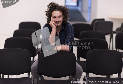 Image of A student sits alone  in a classroom