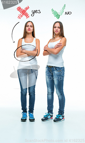 Image of conceptual portrait of two beautiful twin young women