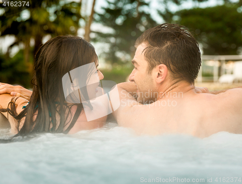 Image of Young couple in a jacuzzi
