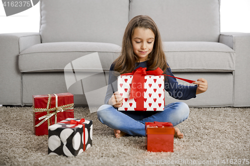 Image of Little girl opening presents